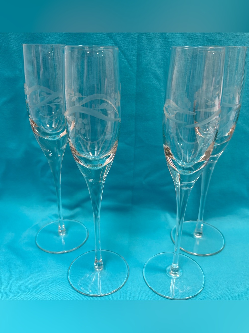 Etched glass champagne flutes with swirl and flower design